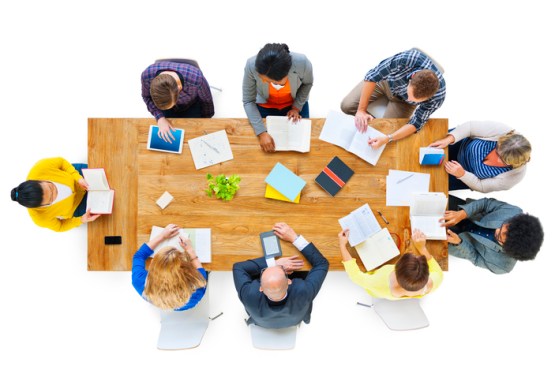 Group of Business People Reading Notes on a Meeting Table